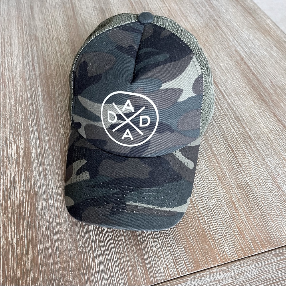 Tiny Trucker brand hat, ‘DADA’ cross style symbol, trucker style adult hat